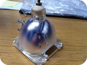 Counterfeit DLP projection TV lamp with tinted reflector showing poor quality manufacturing